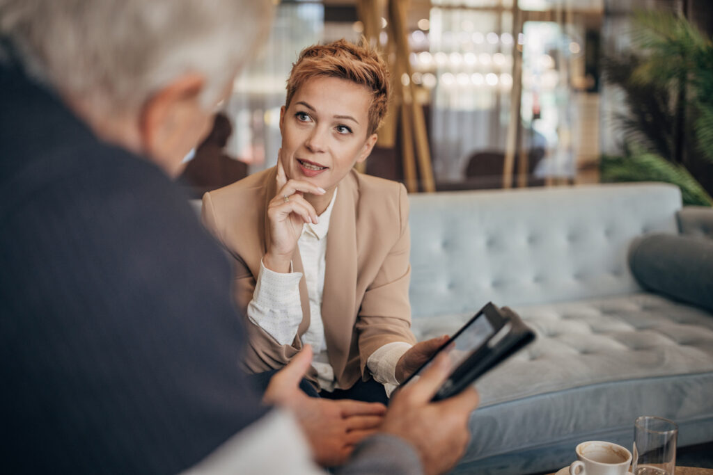Father and daughter talking about business in luxury hotel