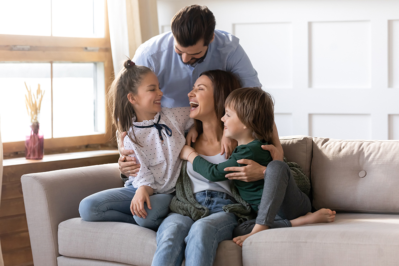 Happy young family with kids relax at home